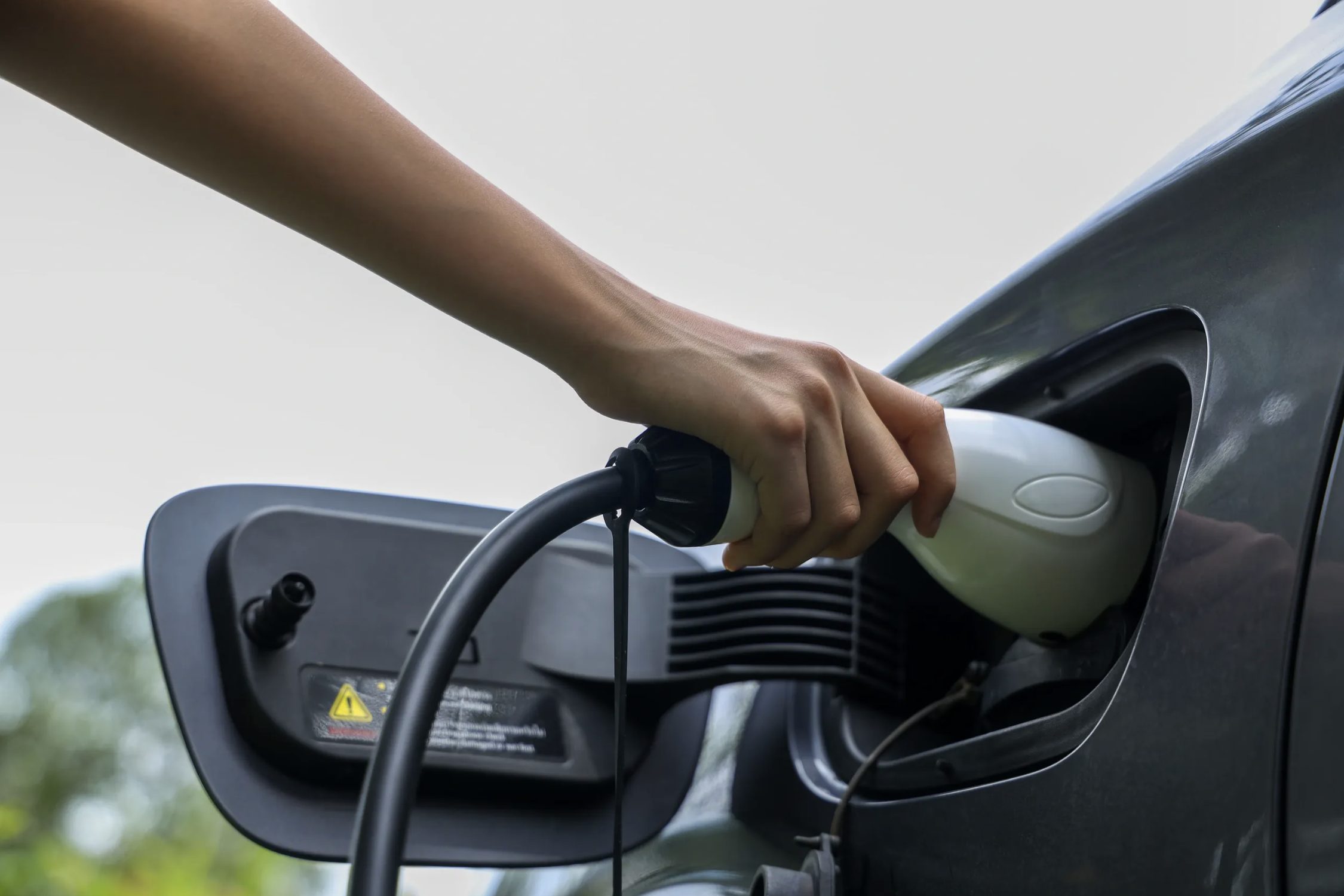 Plugging an EV charging connector into a car